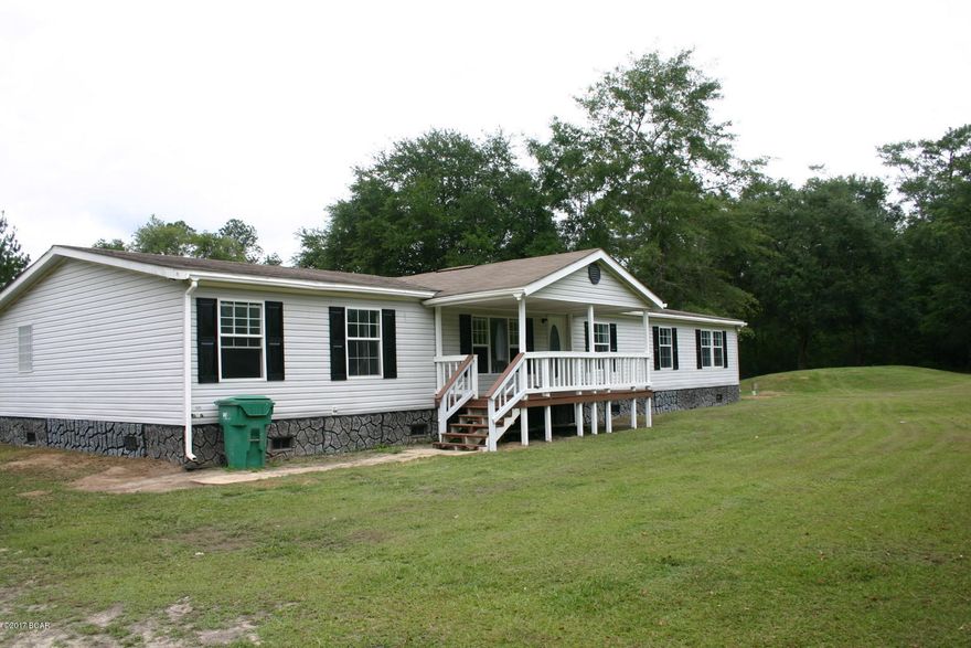 Looking for that country home? Massive 4/2 doublewide on 5.5 acres with two small ponds. The home features a large kitchen, spacious master bedroom and bath, huge hallway leading to the other 3 bedrooms, and a large family room (14'6'' X 27'3'') with fireplace. Seller just finished replacing flooring and painting the interior. If you need lots of space, you need to check this one out!