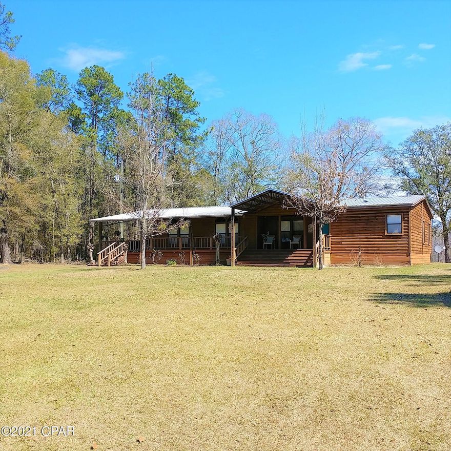Beautiful waterfront 3-bedroom, 2-bath mobile home in the country on 20 unrestricted acres. If you are looking for your own piece of paradise that offers seclusion and privacy, and no visible neighbors, then this is it !!  Home is in great condition and ready to move into.  Huge living room with a wood-burning fireplace and plenty of room for your furniture.  Master suite features a large bedroom and bath area.  The other 2 bedrooms are spacious with a full bath in between.  Nice kitchen with plenty of cabinets, a great island, and stainless steel appliances.  There is a 48X40 pole barn and an additional 16X24 barn for storage.  Located just outside of Westville, FL near a nice family park with water pad, track, and basketball goals.