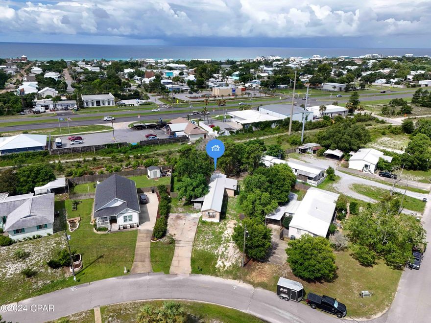 Large Lot in Panama City Beach for Sale for under $150,000!!  Located a few blocks from the Sandy Sugar White Beaches in Panama City Beach!  Value is in the Land, that is almost 1/3 acre.  Older mobile home is on the lot, that can be renovated or removed.  This large lot gives you options to build a 2nd home, investment property or your Beach home!!!  Property is right off of Hwy 98, so easy to cross 98 and walk down Malaga straight to the beach!  Conveniently located to Back Beach BBQ, Dairy Queen, Pier Park, Frank Brown Park, tons of shopping and Restaurants.   Close to 30A going West.  Lots of shopping and restaurants.  Don't miss this opportunity to have a large lot in PCB and make it what you want!!
