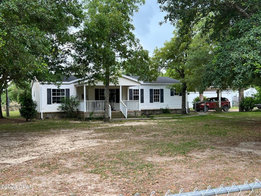 Impressive 3/2 double wide with 2 car carport built on, home has brick skirting, New roof in 2020, recent survey, recent 4 Point Insp,  large chain linked fenced in front. Long concrete drive way, big master bedroom with huge master bath and closet. Double master sinks.  All new laminate flooring through out the home. Split bedroom design for Master privacy. Plenty of kitchen cabinets with new deep sink and new refrigerator. Outside is a 12 x 18 back deck, 24x36 pole barn, 2 additional storage buildings, and plenty of shade.  Compass Lake is only 2 miles south for excellent fishing or swimming or boating.  Hwy 231 is only 1 mile away. This home shows very well. Make your appointment today.