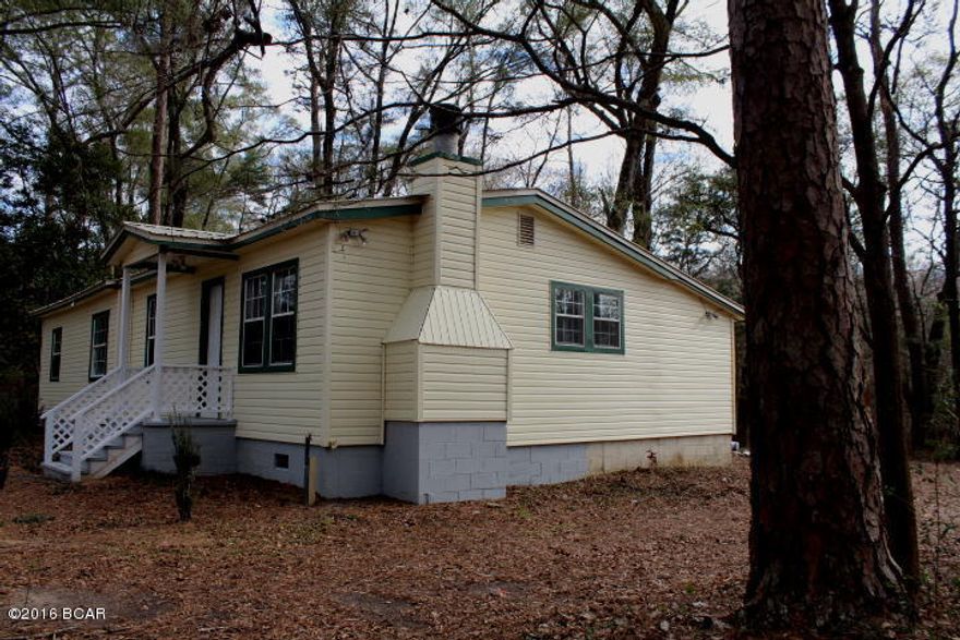 Lovely updated home on 10+ acres with a pond!  House is very nice with all new floor coverings, new kitchen appliances, fresh paint, new rear deck and more!  The home features a split bedroom design. There is a large living room with fireplace.  If you are looking for a peaceful setting this is it!  Most of the property is natural woods and there is a fishpond on the rear of the property.