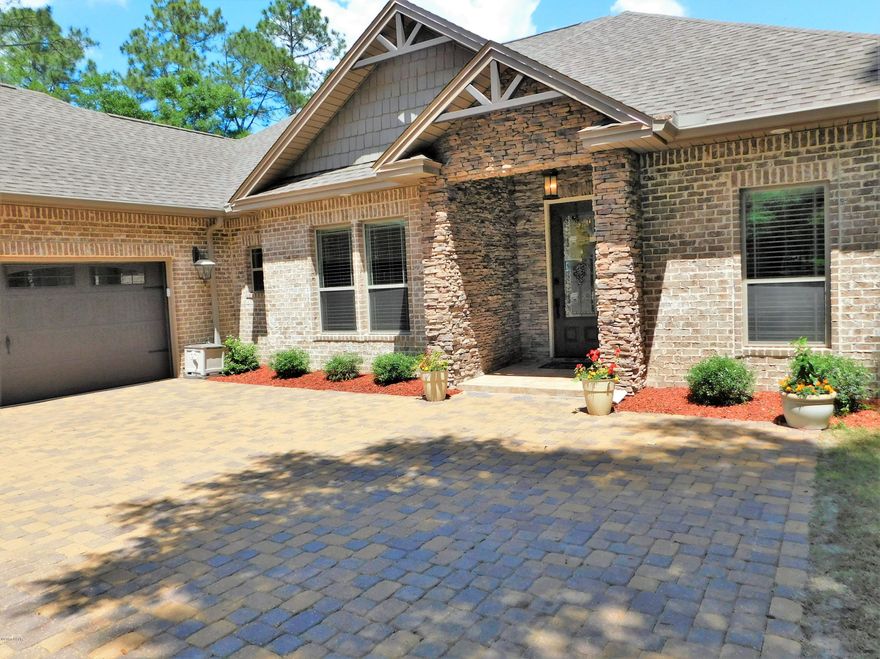 PRICE REDUCED! WATERFRONT LIVING AT ITS BEST in this highly sought after Lynn Haven gated community, Grant's Mill II. You will love all the extras this beautiful custom built split 4 Bdrm/2.5 bath waterfront home has to offer.  Perfect for a family who love the water and outdoor living. Elegant 10' ceilings with crown moulding and beautiful porcelain tile floors adorn the open floor plan as you enter the home. The dining area features an 11' trey ceiling. The large and comfortable living area boasts a 12' trey ceiling,  electric log fireplace and stunning views of the bayou; the living area opens into an outdoor living screened back-porch. The kitchen has granite counter tops, stainless steel appliances, and loads of custom cabinet space. The Master Suite w/ stepped up trey ceiling is spacious and features a large tiled master bath w/ custom cabinets, granite w/ double vanities, garden tub and a large walk-in closet; Access from the Master Suite to the porch allows ease to relax and enjoy waterfront living.  2nd and 3rd Bedrooms are porcelain tiled with large closets and hall bath.The bonus room which is counted as the 4th bedroom, can be used many ways including an office, game or media room. The spacious laundry room has built in cabinets. Bring your boat, kayaks, and jet skis. The bayou has navigable waters leading to the open bay and gulf.  The 110' dock features MasterDeck decay resistant wood. Patio just off of the porch is perfect for barbecues and socials. Additional parcel of land at water's edge makes this property valuable and unique.  Brick pavers grace the streets and driveways of this home and neighborhood. 1% buyers fee.  Energy efficient and low-maintenance exterior. All sizes, including sq. ft. are approx.  Please verify if important.