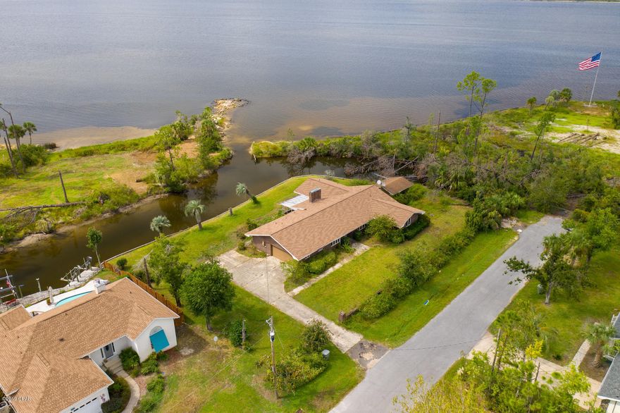 CURRENTLY UNDER CONTRACT SELLER ACCEPTING BACK UP OFFERS. Excellent waterfront opportunity in Lynn Haven.  With calm protections of a canal and views of the St. Andrews Bay, this Hurricane Michael damaged home has great possibilities.   The structure is gutted down to the studs and the roof is new so you may want to renovate or tear it down and start over with your own plans.  Buyer should verify all information and sizes.  Take advantage of this new opportunity and act now.
