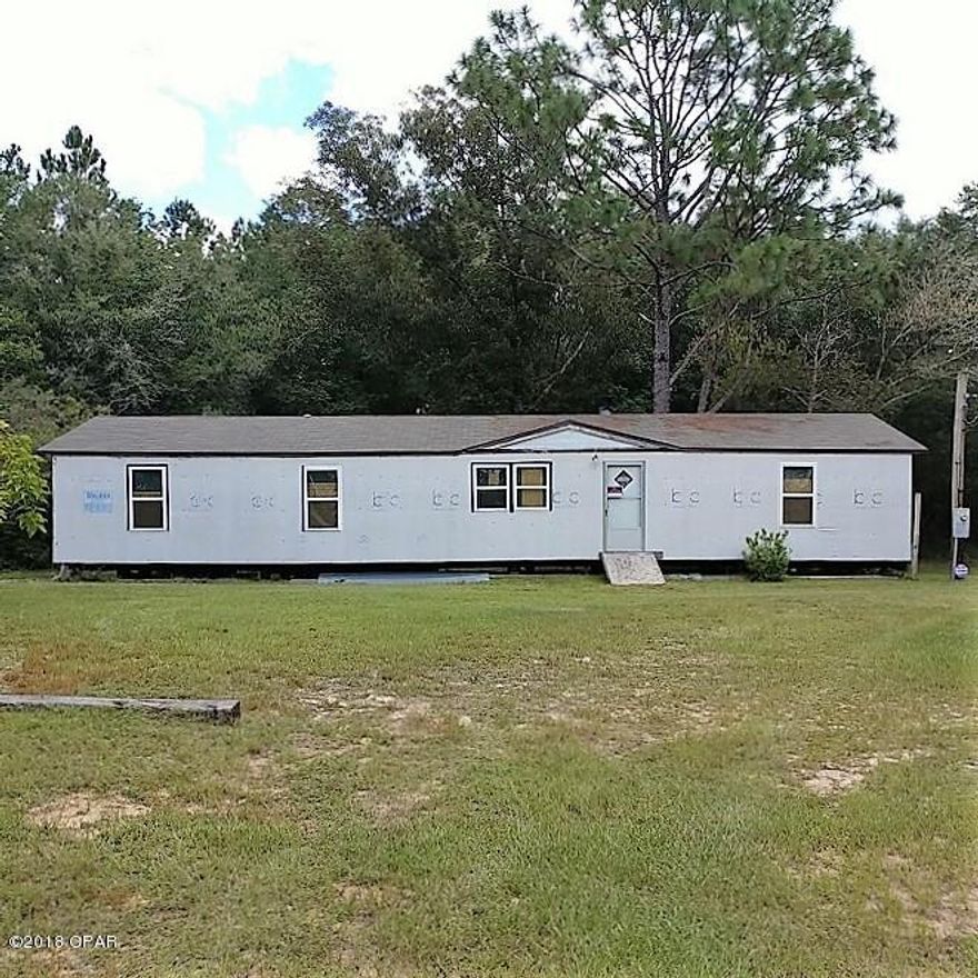 3-Bedroom, 2-Bath doublewide mobile home on 4 acres just south of DeFuniak Springs.  Home has been gutted, but it is clean and ready to be restored. Already has new double-pane windows and new back doors. It has good floors and a good roof with no leaks. Wood-burning fireplace. Well pump works and septic was pumped 2 yrs ago and drain lines were replaced.  There is an enclosed outside shower with hot and cold water.   Also has an RV hook-up to use while you work on the mobile home.  Home needs wiring but the Seller will provide wiring.  Needs plumbing and hvac. Partially fenced. An 8X20 Conex storage building is included. There is a small creek on the back of the property and a power easement runs along the back side of the land. Survey markers are in place. All information to be verified.