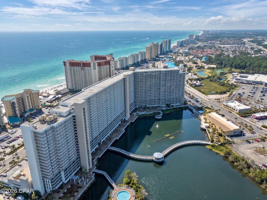 Experience the best of coastal living with this Gulf-side condo at Laketown Wharf, offering a front-row seat to some of the most incredible Florida sunsets. This spacious 3-bedroom, 2-bathroom residence features a thoughtfully designed floor plan that truly feels like home.

Inside, the open-concept layout creates a seamless flow between the kitchen and living areas--perfect for relaxing or entertaining. The kitchen is well-appointed with granite countertops, stainless steel appliances, and ample space for gathering. The living room has been updated with luxury vinyl plank flooring, adding both style and durability, while the in-unit washer and dryer provide everyday convenience.

The Gulf-front primary suite serves as a private retreat, complete with direct balcony access and a spacious en-suite bathroom featuring a double vanity, large soaking tub, and a walk-in shower.

Step outside to your expansive private balcony, where you can unwind and take in breathtaking views of the Gulf--an ideal setting for morning coffee or evening sunsets.

Laketown Wharf offers an unmatched resort-style experience with an impressive list of amenities, including: Five unique pools, including a rooftop pool and Gulf-view zero-entry pool, Direct gated beach access, Famous nightly fountain show, On-site dining, buffet, and bars, Fitness center, Covered parking. 

The monthly HOA covers cable TV, WiFi, insurance, security, and all resort amenities, making ownership both convenient and stress-free.

Whether you're searching for a primary residence, vacation getaway, or income-producing investment, this Gulf-side condo offers the perfect blend of location, lifestyle, and value.