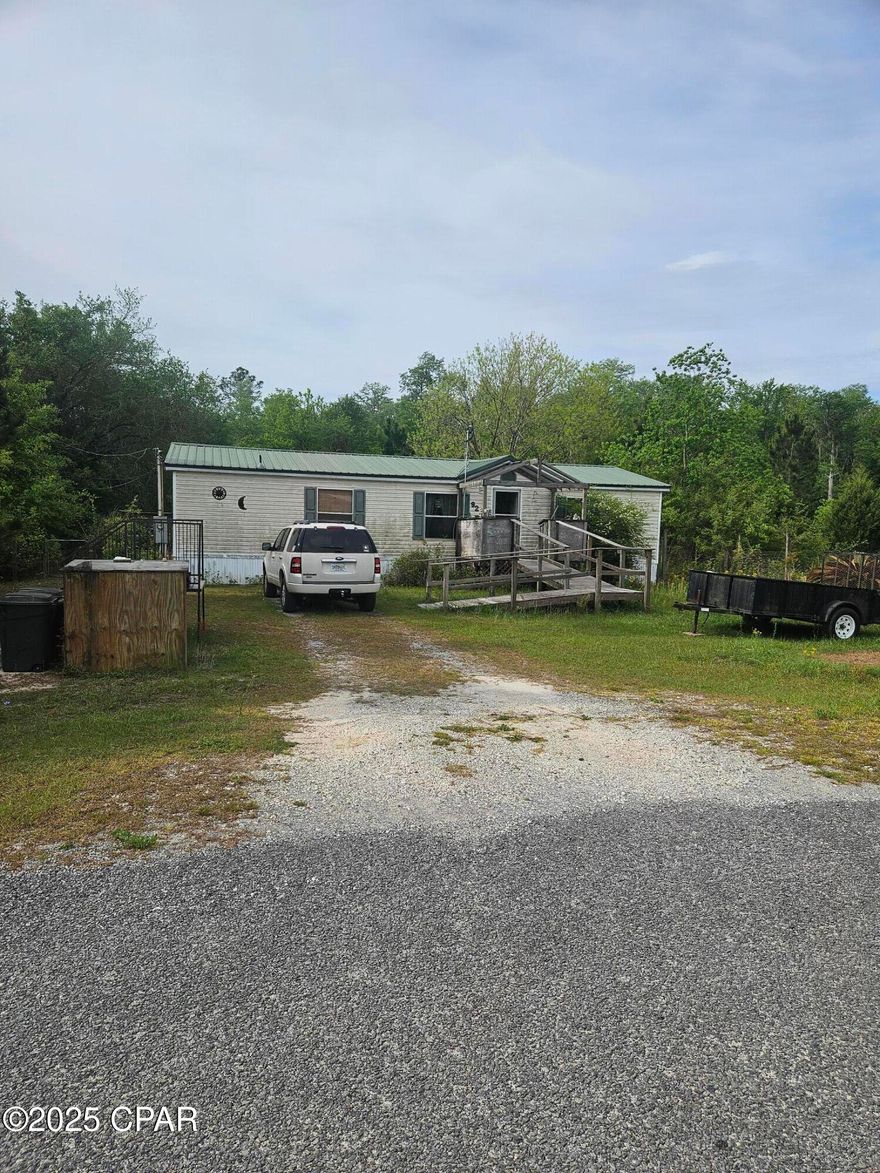 This older mobile home is being sold as-is and offers a great chance for someone with a vision and a toolbelt. The seller is currently in the process of moving, so interior photos are unavailable at this time. The home is in need of significant TLC and would be ideal for a handy buyer or investor.
Situated on just under an acre, there's plenty of space to create your own private retreat. Please note: heating and air conditioning systems are not currently operational.