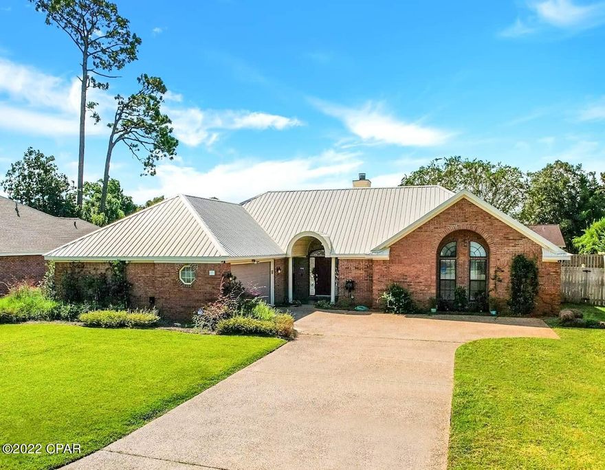CURRENTLY UNDER CONTRACT, SELLER WILL CONSIDER BACKUP OFFERS - Prime location in the desired area of Grand Lagoon Shores just minutes to the beach, St. Andrews State Park, local restaurants and marinas! This all brick 3 bed/ 2 bath home features a BONUS room used as an office, a saltwater pool, and a NEWLY RENOVATED kitchen and master bathroom! The kitchen has new soft close cabinetry, white quartz countertops, a large walk in pantry, and stainless steel appliances. The master bathroom is an oasis complete with a quartz double vanity, a stand alone tub, walk in shower and master closet. Other key features include: privacy fenced in yard with a patio for outdoor entertaining (.3 acre), oversized garage with built-in storage, freshly painted throughout, Florida room with large windows smart home capabilities, exposed brick, wood burning fireplace, and other custom detailing. FLOOD ZONE X. Metal roof installed 2013, and HVAC system installed 2016. THIS IS THE HOME! Call your realtor today to schedule a private showing!