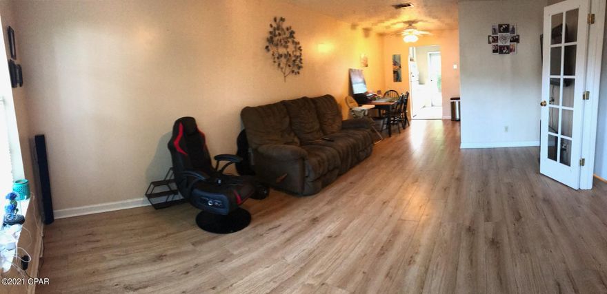 Cute cute 2 bedroom 1 bathroom home in a triplex that would make a good rental property, first time home or down size opportunity.  It is in good shape and currently occupied by a tenant.  (Please do not disturb them).  It has newer floors and fresh paint throughout with the exception of the laundry room.   The home has a newly fenced backyard with a pet door so it is great for those with fur babies.  You'll love the producing lemon tree in the yard too! The home even has a 2 year old new roof.  It is close to shopping, restaurants and 30 minutes from the beach.  This is one of the few move in ready, affordable places to live in Lynn Haven.  Call for a personal tour before someone else snaps it up!