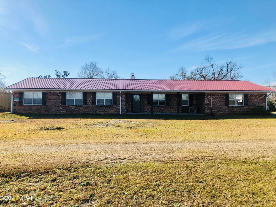 RETREAT TO THE COUNTRY.  Here's a Brick 4/3 on 10 acres 10 min. from town. Inside has been updated with all new flooring, new paint, fixtures, new metal roof in 2019, Jacuzzi room, nice fireplace, update windows.  Large pole barn with all concrete floor with enclosed cooking area, extra spot for RV with own septic Tank and hook ups.  I-10 about 3 miles and Panama City about 45 min away. On the 10 acres there's a pond for fishing and excellent hunting.
