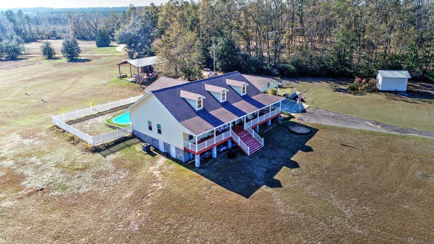 Absolutely beautiful Southern charm. Secluded in the middle of 13+ acres. This home is a custom built home so many extras you will just have to see. Large wrap around porches to relax and enjoy. Large shed for your RV or motor home. This home has hardwood flooring  throughout main area of home. beautiful large kitchen with a eat at bar, loads of cabinets, gas stove top and electric oven so light and airy with the huge window over kitchen sink. Large family room  has a beautiful gas fireplace and is great for entertainment. Split bedroom plan and all has handicap accessible including bath with a walk in tub and separate shower. Even though the front of home has steps the side entrance is ground level into home. Enjoy the inground pool and relax. Age, Square Footage, and room sizes approx., if important please verify.