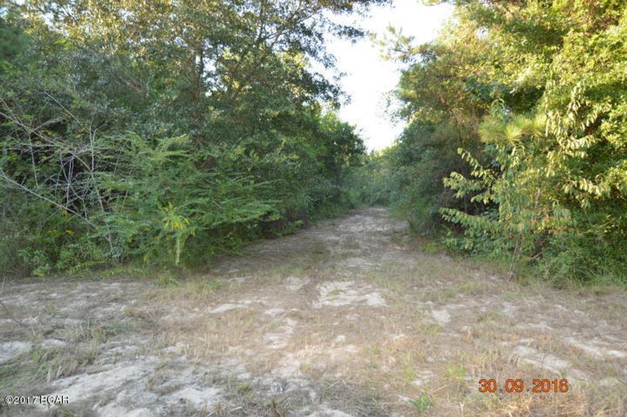 Property backs up to Holmes Creek in Jackson County; is in a private country setting and is mostly wooded. It has city water available and could be used to build a home.