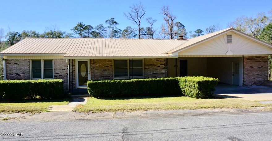 Enjoy a nice home on large (1.56 acres) lot right in town! This 3/2 is located in a quiet neighborhood in Chattahoochee.  The all-brick home features original hardwood floors in the main part of the home and a well-done addition to add a large second living area complete with wood-burning fireplace and built-in bookcases.  The kitchen features sturdy wood cabinets, lots of counter space, and a great gas stove. The front living area hosts space enough for a dining area as well as an additional sitting room. Custom blinds have been fashioned throughout and a storm door is installed on the front door. Home comes with some furniture and washer/dryer. There is a double carport and large covered deck overlooking a vast lot with fruit trees. Minutes to Lake Seminole and Apalachicola River. There is a utility room with washer/dryer (staying with the house) right off the carport.  Additional storage in attic and basement areas of the home. This is a great home, located minutes from historic downtown Chattahoochee, the Apalachicola River, and beautiful Lake Seminole! Only a 45-minute drive to Tallahassee.