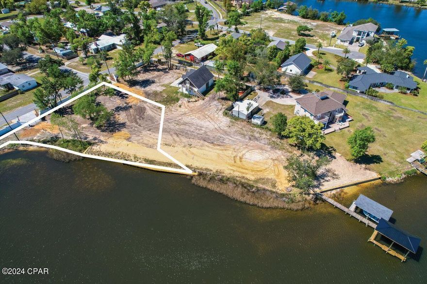 Build your dream home on this waterfront, ready to build lot in the charming town of Lynn Haven, Fl. A privacy wall and coded gate access has been added and makes an big impact to the entrance of this beautiful area. With its close proximity to schools, parks, and shopping, this lot is not only beautiful but convenient as well.