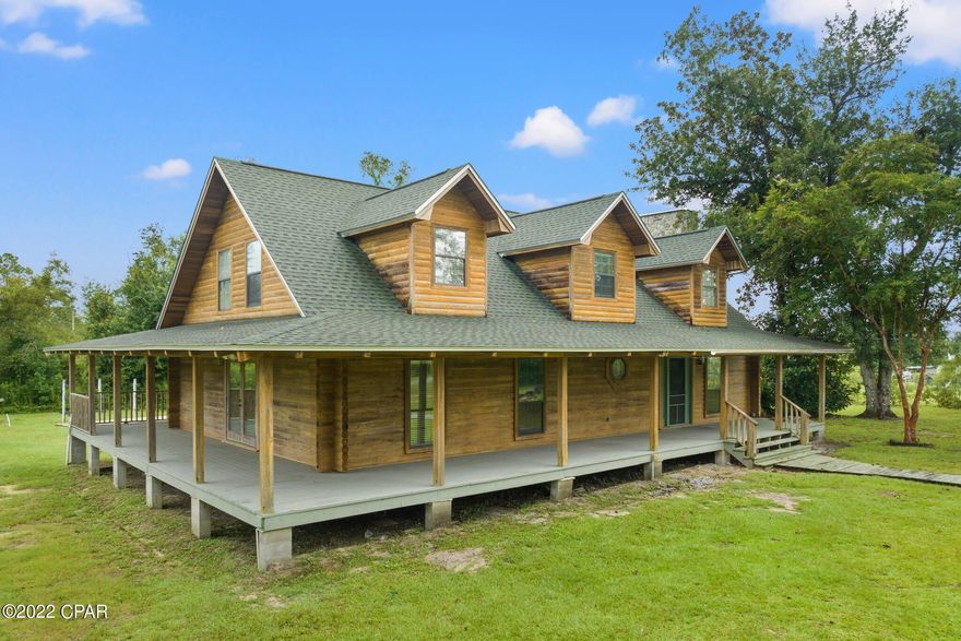 CURRENTLY UNDER CONTRACT.  SELLER WILL CONSIDER BACK UP OFFERS.  If you're looking for a spacious home on a nice (1.2 acres) property, you've found it!  The log home features a large wrap around porch to enjoy the outdoors. The backyard has a covered deck and large, sparkling pool.  There is a 40' x 22' RV pad that has water, sewer, and a 50 amp hookup.  This home features 3 bedrooms as well as a 4th room that can be used as an office, craft room, or add a closet and it's another bedroom.  The family room has 2 story ceilings and a wood burning fireplace.  The unique kitchen features copper countertops and lots of storage.  The large master bedroom opens into a spacious master bath with jacuzzi tub, separate shower, and two pedestal sinks.  Large master closet is cedar lined.