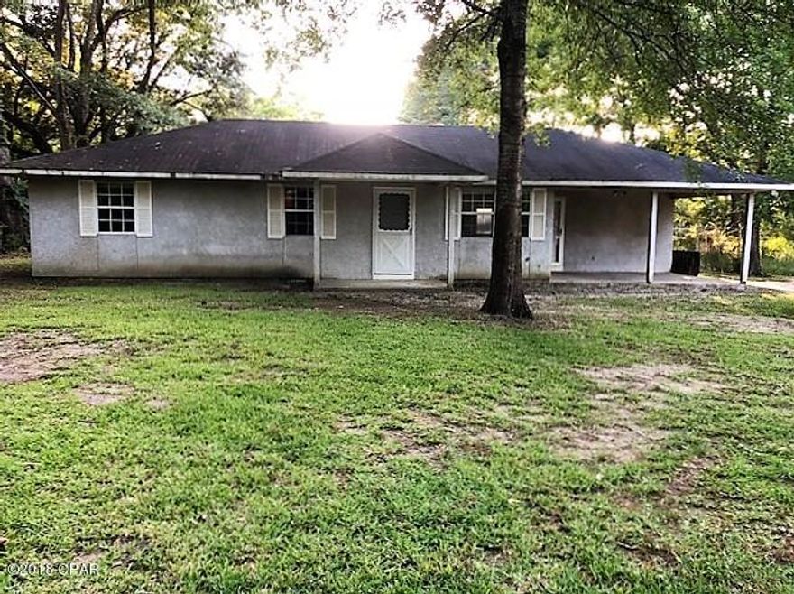 PRICE REDUCTION!! This house sits back off the street affording you some privacy while still in town in a convenient location.  House has an eat-in kitchen, 3 bedrooms 1 and 1/2 baths. It has an extra large inside utility room and there is an outside storage room. It has an attached carport and there is a fenced back yard.  Some updates needed but a good investment property or will make a great first time starter home.