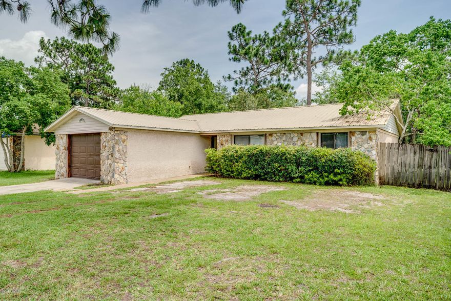 This is a lovely home! Convenient to Tyndall Air Force Base. This home has tons of potential and has been well cared for. This would be the perfect starter home or a great investment property. Split bedroom plan with three spacious bedrooms and an open living area and kitchen with breakfast bar and stainless steel appliances. Master en-suite is spacious with large walk in closet. Nice tile flooring in main living areas and bedroooms and bathrooms. Fresh interior paint. Metal roof. Large sized fenced yard with gate access and a privacy wall between the home and the street for added privacy. All sizes are approximate. Please verify if important.