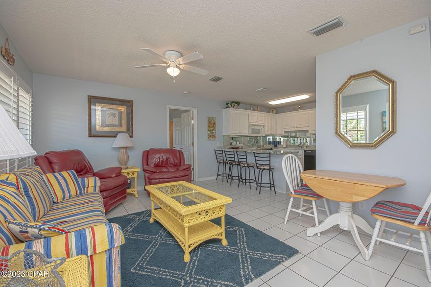 This beautiful condo is ideally situated within a short walk of the sandy white beach and the stunning emerald waters of the Gulf of Mexico. It features two spacious bedrooms, two bathrooms, and comes fully furnished, making it ready for immediate occupancy. The open floor plan provides a generous living space, and additional bunk beds offer flexibility for accommodating guests or children. 
The well-equipped kitchen includes a breakfast bar for convenience. The condo also boasts a relaxing balcony. Horizon South is a gated community that provides beach access and an array of amenities, such as five swimming pools, tennis courts, shuffleboard, a hot tub, an exercise room, and a game room with pool tables. Mini golf, basketball courts, a gazebo, and grills are also available for residents and guests to enjoy.
The location is ideal, with close proximity to Pier Park, the airport, restaurants, and entertainment options. On-site management is available for added convenience. This pet-friendly property allows both long-term rentals and vacation rentals, making it a versatile and attractive investment opportunity for those looking to enjoy or monetize this beautiful beachside condominium. All measurements are approximate. If important, please self-measure. (Large clock above TV in living room is not included in furnishings)