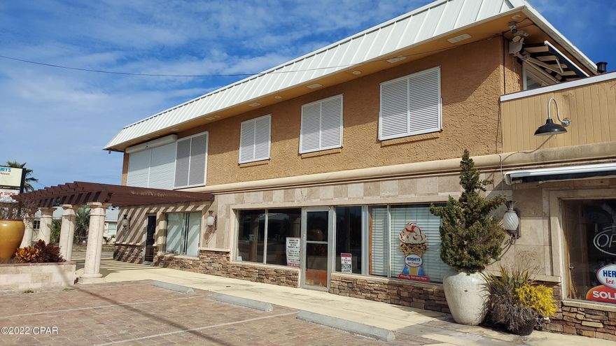 Last large parcel within walking distance approximately 400 feet to Pier Park. Beach access directly across from the property. This property consists of four lots within two parcels. Zoning is T-3 for this property and there is 200 feet of road frontage on Front Beach Road with ocean views. There is access to the whole property on the back from a residential street.The commercial zoning allows multi-use for almost everything: townhomes, condos (possibly 12), motel, retail, etc. Zoning allows for three stories with 35 foot height from the center elevations of the road to the top ceiling. Land is very level, so there appears to be very little fill needed. Now, with all the extensive building going on with homes on the west end of the Beaches, the value is obviously in the land BUT currently on the property is a 6000 square foot building that has multiple business opportunities. First floor is retail that was an ice cream shop and bar/lounge. New front facade with stacked stone, travertine and stucco finish on block walls as the front appearance. You could actually sell off the two lots and still have parking for the remaining businesses both street front, side and behind the business. The second floor is residential and was remodeled in just the last few years with new sunning deck, new back roof, Plantation and Bahama shutters, extensive security system covering all the property, new electrical and many upscale items. SO, opportunities abound on this property and the value is definitely here for the right buyer.