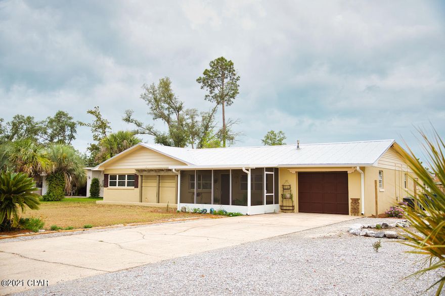 Nice 4 Br 3 Ba, 2 living rooms, 2 dining rooms, 2 kitchens- Seller Offering 10k New Window Allowance to Buyer!   Not in a flood zone. The home is located on a large lot that includes 10+ parking spaces. It has a newer metal roof and 2 skylights, the floors are ceramic tile, luxury vinyl and carpet. The interior is newly painted. It has spacious rooms and a large master bedroom with a sunroom and extra large master bath. There are 2 new central heat and air units, a wood burning fireplace, a screened in porch, large covered porch, one car garage, washer and dryer hookup and an irrigation well. (sprinkler system not warranted)

Bonus: 10'x20' - 200 sq ft. workshop /storage building with electricity, man/woman cave, or a children's play house or maybe a teenager getaway. No homeowners assn.