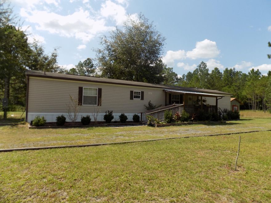 Move in ready home on just under an acre of land! This home is spotless inside and ready for a new owner to care for it.  This 3 bedroom 2 bath home has an eat in kitchen dining area, large living room, interior laundry room, front porch, detached carport that holds 2 cars and a nice storage shed.  There is also a ramp for wheelchair accessibility and a fenced in backyard.  There is so much to love about the home.  Septic, Well and Power Pole were all put in when the mobile home was moved there in 2013.  Schedule to come see it today!