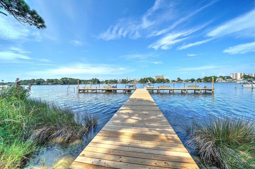 Palisades is a peaceful waterfront complex with great views, a new dock, and a community pool- Located on the Grand Lagoon, make it a point to see this 2 bedroom, 2.5 bath townhome with a carport and outside storage. Enjoy your private patio and watch your plants grow with an abundance of sunshine. Drink a cup of coffee or your Smoothie on your balcony as you watch  the beginning of a new morning. Walk the property and you feel like the grass below your feet is like carpet. Make this your permanent home or a great getaway- No short term rentals are allowed so it is very enjoyable and quiet. You will not be disappointed.