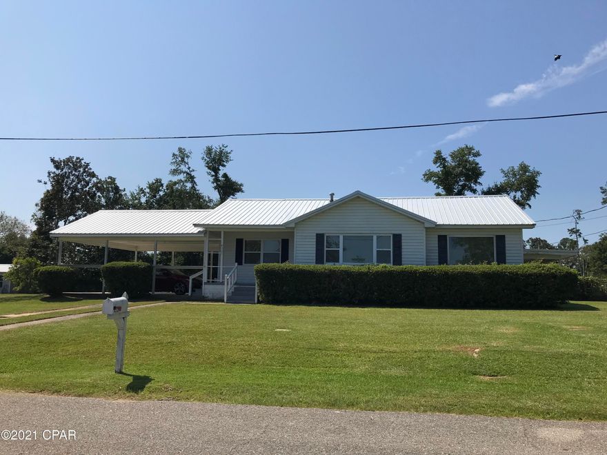 PRICE REDUCTION - Bring all offers -  Gorgeous 3 bedroom/2 bath home that has been completely remodeled.  Home sits on 3 corner city lots with over a half acre. New metal roof, all red oak floors have been newly sanded & sealed, new custom double pane Low E window & aluminum blinds.  New front & rear doors, painted interior & exterior, new light fixtures, painted cabinets, new stove & backsplash.  Washer & Dryer included.  New 200 amp Breaker Box & 100 amp exterior.  New auxiliary HVAC pump in rear family room & main HVAC completely rebuilt.  Home has a double carport on one end  & a single carport on the other end.  Make this your home today.   Call for an appt.  to see this home today.