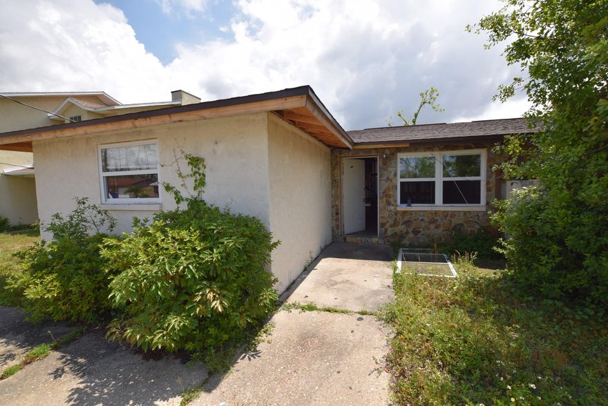 Investment opportunity! Great concrete block townhome with new roof and windows.  The interior has been demo'ed to the studs.  This property is perfect for a flip or as a rental property. Property sold as is.  All measurements approximate, verify if important.