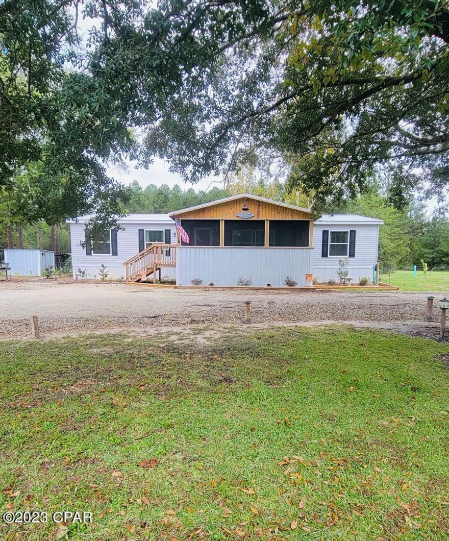 Country living at its finest. Located in the five acre farms area in north gulf county, a 3 bedroom 2 bath manufactured home on 1.1 acre corner lot. Walk in the front door to open living concept with a custom built fireplace with book shelves and cabinets on each side. The kitchen features a large island with a farmhouse sink. Upgraded stainless appliances. The soft close wood cabinets extend from floor to ceiling and frame the refrigerator on one wall. The rest of the kitchen has plenty of cabinets and plenty of workspace. It has a split bedroom floor plan. The large master bedroom is carpeted with a large walk in closet with wood shelving. The master bath has a double vanity, garden tub and large walk in shower. Additional bedrooms are carpeted with walk in closets and share a full bath with an oversized tub. There is a bonus room that can be used as an office. All the walls in the entire home are sheetrock . All exterior framing is 2 x 6 's, with a galvanized metal roof. The laundry room is just off the kitchen and features a pantry plus a spot for freezer. Enjoy the evenings on large 12 x 22 screened in front porch. The property features a circular drive and 24 x 48 concrete floored pole barn with enclosed garage which is all insulated. New well has a Culligan whole house water softener system with R/O in kitchen. There is a 15' x 4'' deep above ground pool with sand filter and upgraded child lock ladder. The entire yard is fenced with 6 x 6 post and field fencing. There are 12 ft cattle gates for the entrances. There are many varieties of trees, blueberry, fig, orange, kumquats. Also magnolia and crepe myrtles. The driveway circles around the beautiful oak tree in the front of the property. The nearest town Wewahitchka is about five miles and has grocery and hardware store. The Apalachicola river, the Chipola river and the Dead Lakes are nearby. Both Port St Joe and Mexico beach are about 30 minutes away. Well & Septic installed in 2021