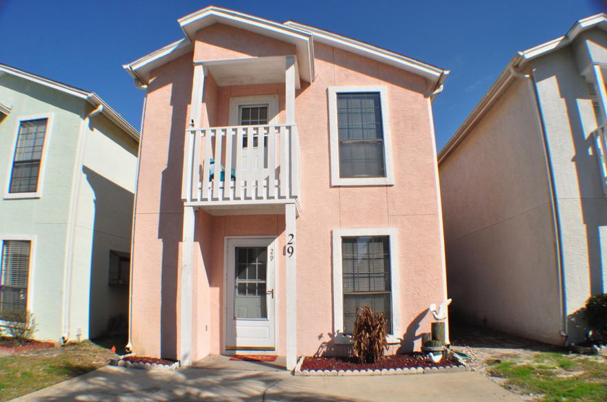 Great 2BR/2.5BA unit in Sand Castles West! This home has the wood look ceramic tile flooring in the living room with French doors that open to a private patio. The eat-in kitchen features a lovely garden window and all appliances convey.  Upstairs, the master bedroom has two closets, one a walk-in and the second bedroom includes a balcony. There is also a lot of storage available in this unit.  Sand Castles West is a condominium and master association takes care of the exterior maintenance and the amenities include two swimming pools, a picnic area with grills, a clubhouse and beach access across the street.  You're also only 5 minutes from Pier Park!  All info is approx. and must be verified by Buyers if important.