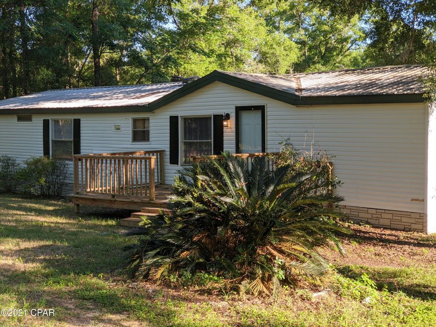 Priced to Sell! 3 Bedroom 2 Bath Doublewide on 2.4+/- Acres in the Southeast Tallahassee area. This Split Floorplan Home features a large living room and den with fireplace that is separated by a sprawling kitchen. The Master Suite Features his and her mirrored closets, as well as a jetted tub and walk-in shower. Outside, the home has a large open front deck, a massive back deck, and numerous oaks. Schedule your showing today!