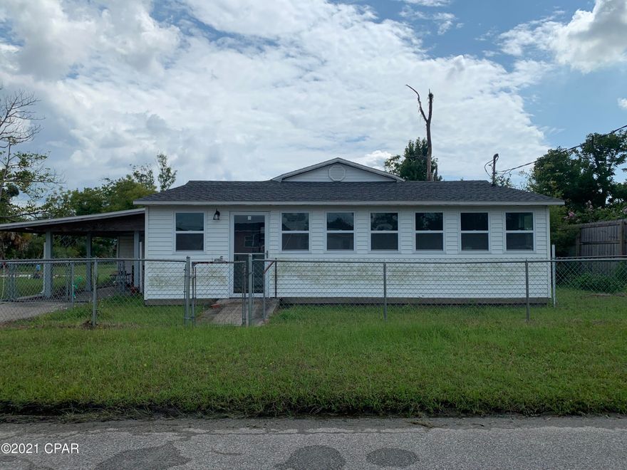 Just reduced!  Endless possibilities with this home on large lot.  This home sits on a large .80 of an acre lot.  The yard is completely fenced in.  There is an attached storage room or utility room under the carport and a large block 1176 sqft detached workshop behind the house.  The home has a new roof and new windows.  The interior has been striped down to the bones inside and is ready to be put back together.  This property would be perfect for someone who has a home based business that would benefit from the large property and big storage building.  If allowed by the city, there may be enough room for a horse.