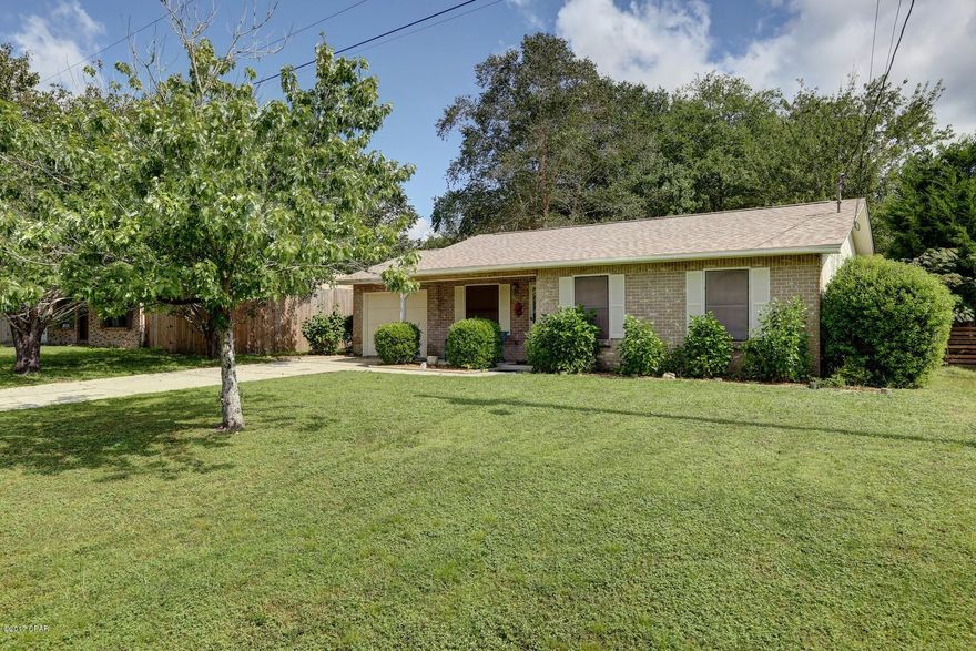 NEW ROOF on this move-in ready three bedroom two bath home.  Nice wood laminate floors throughout with carpet in the extra bedrooms.  This home sits on a nice lot with privacy fencing and a covered patio to enjoy the nice evenings or entertain family and friends.  There is a one car garage with cabinets for neat storage.  The eat in kitchen features a nice pantry and views of the backyard.  The master bath has a large shower and walk in closet.  There are two new exterior doors going into the backyard.  All spruced up and ready for the next family to create their own memories.