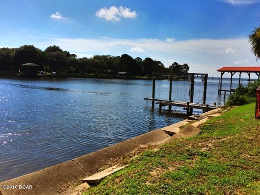 Consider this amazing opportunity to own waterfront property with access to the Bay and the Gulf! The views are spectacular! This large home with its unique exposure to the Bayou presents the boater or fisherman with a canvas to create a dream home. The home appears to have been modified by former owners to section off the house, making it very functional to have separate guest quarters. The first floor has a living area and open kitchen, bedroom and bath. The second floor has a very large room with a full kitchen (great party room), 2 bedrooms, 2 bathrooms and a laundry room. In addition, there is a separate one bedroom, one bath guest house.  Lots of options here! There is also a large yard building, carport,and plenty of paved area for additional parking.