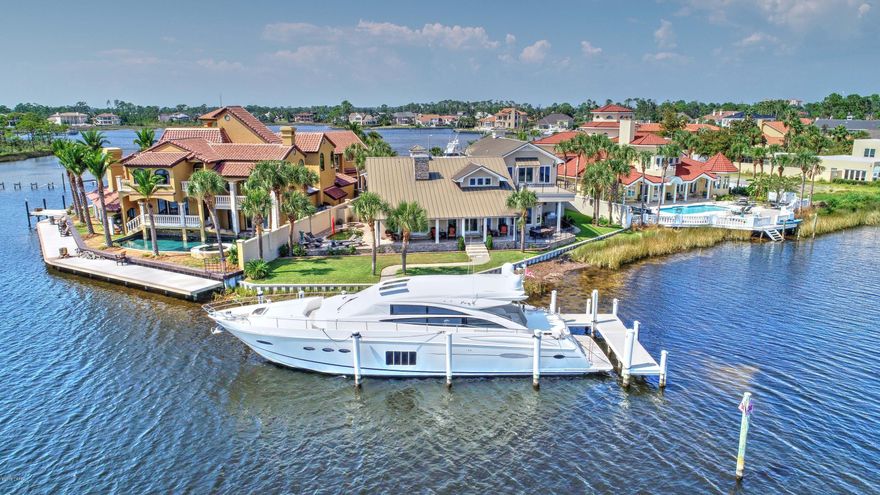 'CURRENTLY UNDER CONTRACT, SELLER ACCEPTING BACKUP OFFERS' This home boasts the most spectacular Lagoon and harbor view in all Bay Point! The state of the art docking facility features aluminum decking and shore power. A 72' yacht currently calls this dock home. The home has been totally updated with the finest materials and appliances. The master bedroom is on the ground floor along with a second bedroom. The kitchen has been been totally updated with the finest granite, stainless appliances, and beautiful cabinets. Upstairs has separate kitchen facilities, 2 bedrooms plus a bonus room with office. The second floor has an expansive deck with incredible views of the Lagoon, harbor and all the boat traffic on the Grand Lagoon!