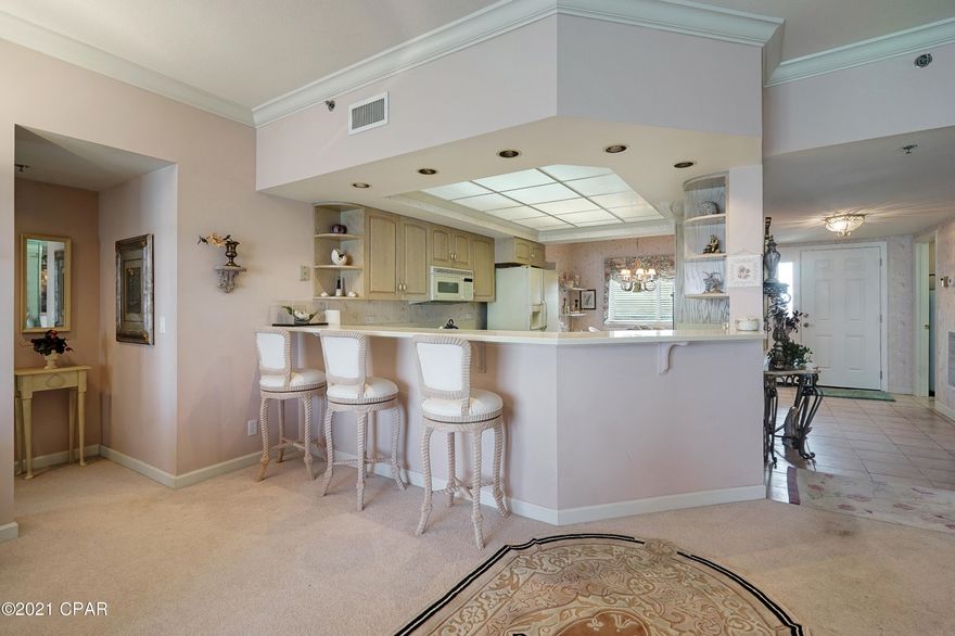 CURRENTLY UNDER CONTRACT, SELLER ACCEPTING BACKUP OFFERS Precious 3 bedroom/3 full bath treasure in the highly desirable Summerwinds!  The amenities & appearance of this complex reflect a long-standing policy of no short-term rentals.  Complex offers: Gated entry from both the street and the Beach; two pools (one heated); workout room; clubhouse; assigned garage; parking lot; 9 ft ceilings; crown moldings and endless Gulf views; with box seats for every sunset to name just a few of the many features.  This property comes tastefully decorated & furnished.  Some surprises include a spacious balcony with a view second-to-none and an extra room that is large enough to provide meaningful space.  By design, extra storage; additional owners storage closet and spacious, open floor plan... ....promotes use of this gem as a primary residence or a low-maintenance vacation home.  Two of the bedrooms have a gulf view and one bedroom has a view of the Grand Lagoon.  Be BOLD!  Call listing Realtor to view.  This one won't last long!!  Measurements are approximate and should be verified.