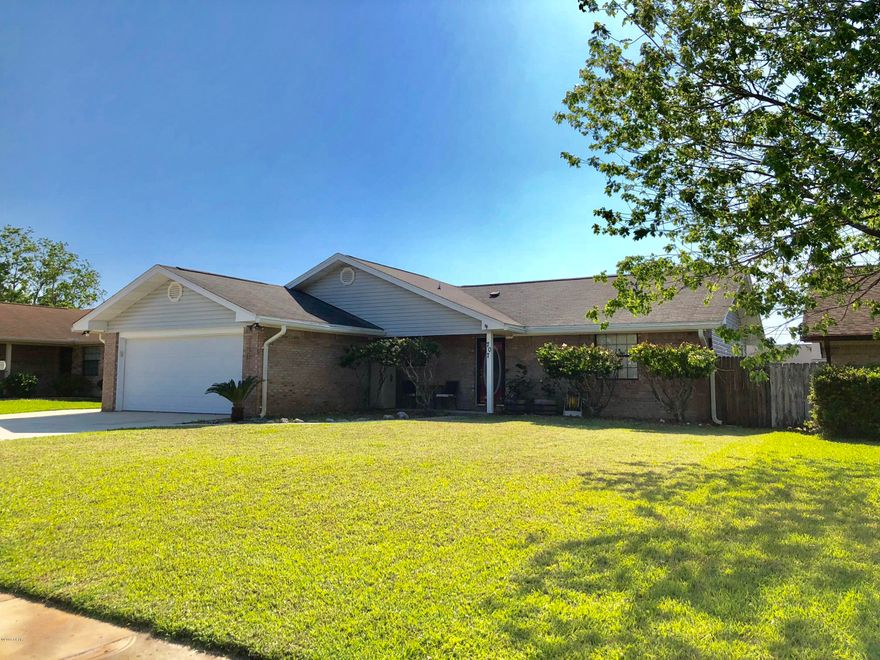 Wonderful move-in ready home and piced right located in a great neighborhood. It is close to Tyndall Air Force base, shopping, churches, charter and public schools, boat ramps, beaches and other recreation. No steps with all on one floor, this 3 bedroom 2 bath split plan home has hardwood and tile floors, beamed ceilings and ceiling fans. The kitchen has cherry cabinets, Frigidaire appliances and quartz counter tops. A pass thru counter to the 17X20 living room features a wood burning fireplace. A large bonus room with excellent natural light off the living room gives wonderful opportunities for entertainment, playroom or additional hobbies. The spacious laundry room between the garage and kitchen is the perfect accent to an excellent floor plan. Easy to love, easy to show! The spacious laundry room between the garage and kitchen is the perfect accent to an excellent floor plan. You will appreciate the walk-in closets found in all bedrooms, including the custom design in the master bedroom closet. The oversize double garage is finished and has a new "quiet belt drive" closer. The rear yard is privacy fenced and ready for children or that special pet. If you are looking for a traditional family neighborhood where everyone takes pride in the appearance of their property, this is it. No association fees and located flood zone X, no flood insurance required. Easy to show, easy to love!