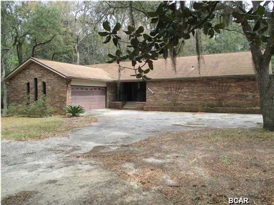 This is a rare opportunity to live on ACREAGE very close to schools, shopping, restaurants and entertainment. This older brick home needs some work but is livable and waiting for the buyer who wants room to stretch out and still be in the wonderful Lynn Haven community. Or, if you are looking to build and want more than a lot, this may be the solution. This 4.2 acre property is covered with beautiful trees and has a stream running through it. The owners have kept much of the property in its natural state giving it a park like feel and appearance.