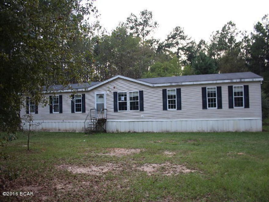 This is a large doublewide mobile home with updates and repairs needed but will make a great investment property! It has 4 bedrooms and 2 baths. The master bedroom has a private sitting room and a very large master bath. There is a den with a fireplace. All of this is situated in 1.3 wooded acres. Location is very convenient to town and local amenitiesa.