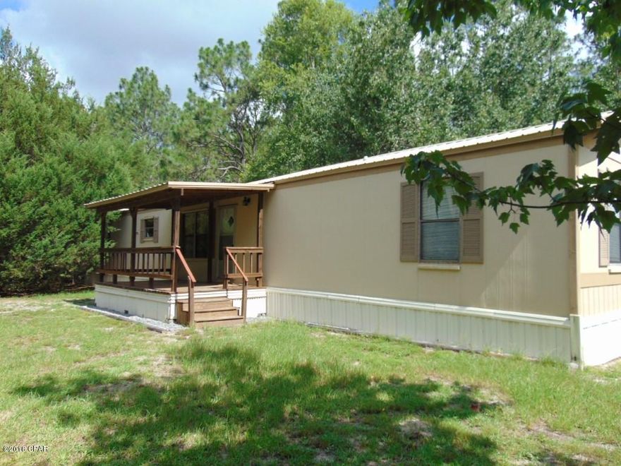 Well maintained three bedroom two bathroom manufactured home on a county maintained paved road on three acres offered as is.  The lot is fenced and faces  the road and a private road for dual access and possible lot split.  The property has a sturdy storm shelter like building, two car covered carport, dog pen, fenced animal enclosure and dog pen, as well as a shed with covered parking for two more cars or boats.

All sizes are approximate or taken form other sources please measure accordingly.