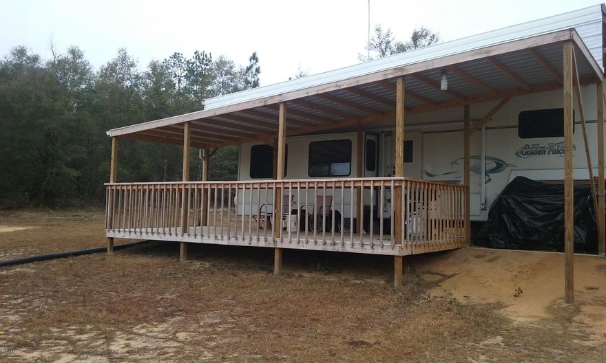 If you want to feel that you can touch the sky, visit this property.  Just stand in the 200' diameter cleared circle and you will know what I mean.  Then take a brisk walk or stroll on one of the peaceful trails that your horse can travel on too to the gate of Econfina Creek.

A heavenly, huge nature-filled land -- can be home for new construction or an inexpensive, used single-wide.  Actually the electric, well, and septic are equipped to handle both at the same time.

This posted property is dry and high (200' above sea-level, highest point 320'), fully-fenced and filled with red fox, deer, and turkey.  Watch the wildlife from the 10' x 24' well-built deck (treated lumber, galvanized roof).  Here you are not only surrounded by nature, but you can step out of the woods and into a canoe.