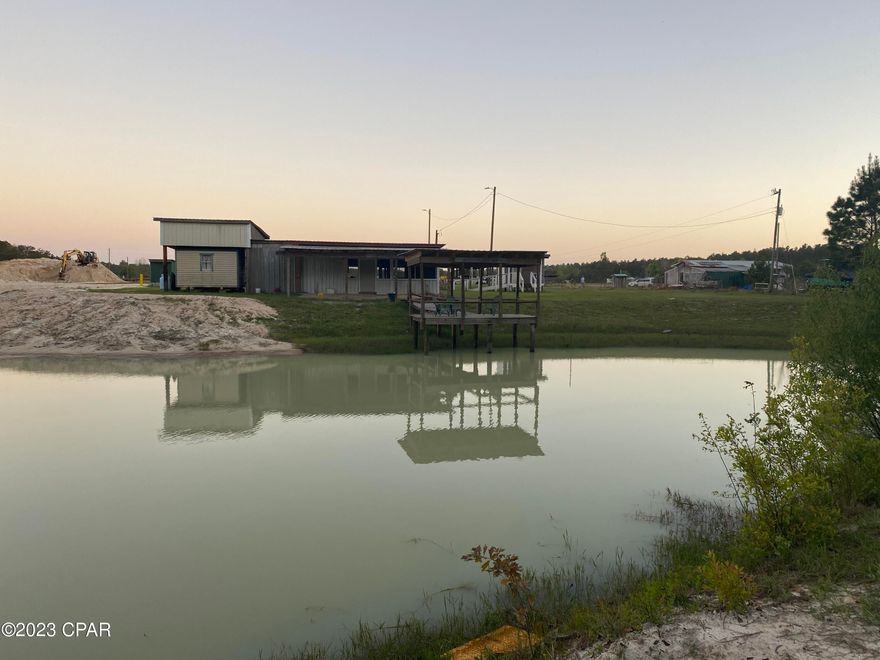 5 acres on a freshwater pond! This beautiful property is being sold with two adjacent parcels of land with a shared freshwater pond stocked with catfish! This property features a pole barn (26Wx60Lx10H), a large enclosed building for a picnic area with kitchenette, a building that is being used for a  bedroom with window unit, a separate building for a half bath with handicapped accessible ramp, and a dock with seating area to enjoy the pond and fish!  Included parcels are ID#00363-402R and ID#00363-410R.

Both parcels of land have a septic tank and one has a private well. 

The dirt on one of the parcels will be removed. Dimensions are approximate. Buyer to verify if deemed important.