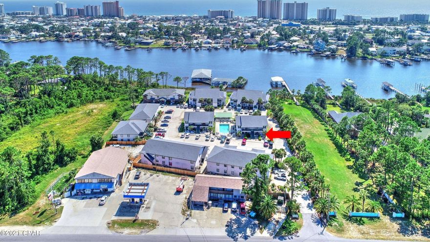 CURRENTLY UNDER CONTRACT, SELLER ACCEPTING BACKUP OFFERS.Fantastic ground floor unit in Greenwood Estates &  it comes with deeded boat slip!  This 2BR/2BA condo has been updated in recent years & offers a view of Grand Lagoon from the enclosed sun porch.  Upgrades include tile & luxury plank vinyl flooring, granite countertops, custom tiled backsplash in kitchen and both baths have designer tile accents, and unlike most units in the Greenwood Estates complex, this unit has a second entrance!  Building 6 is next to the pool & you're just steps from the boat dock.  Speaking of the dock, the deeded slip does have a lift for a pontoon/patio boat.  Low density, easy maintenance, on the water and convenient to everything!  What else do you need?  All info is approx and must be