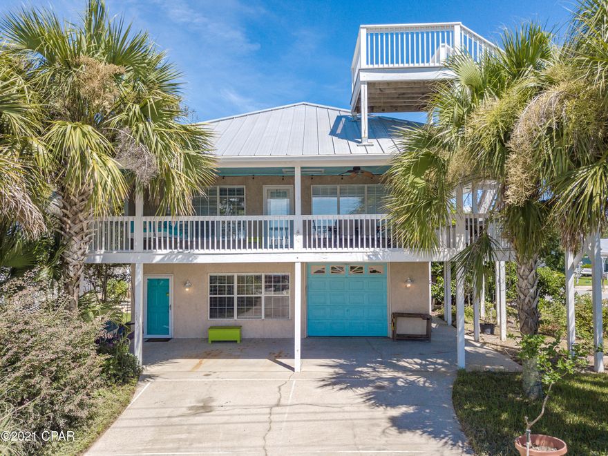SPECTACULAR GULF AND SUNSET VIEWS from the cozy crow's nest!! Make this your primary home, second home, or investment rental...short-term rental allowed and no HOA. This corner lot property is less than two blocks to the beautiful white sandy beach on the desirable west end of Panama City Beach. Great open floor plan on second level with fireplace and kitchen/living room combo, which leads out to a spacious covered porch where you can enjoy the Gulf breezes with a comfy bed swing, dining table, and plenty of room for entertaining. The porch wraps around to an additional covered deck and the stairs up to the crow's nest. This home boasts three bedrooms, each with a private bathroom. Downstairs bed/bath/living room could be converted to a private living space. Enjoy the private outdoor hot shower in the fenced backyard when you get back from the beach. Deep one-car garage with room for small workshop. Plenty of mature fruit trees and established garden area for you to enjoy!!