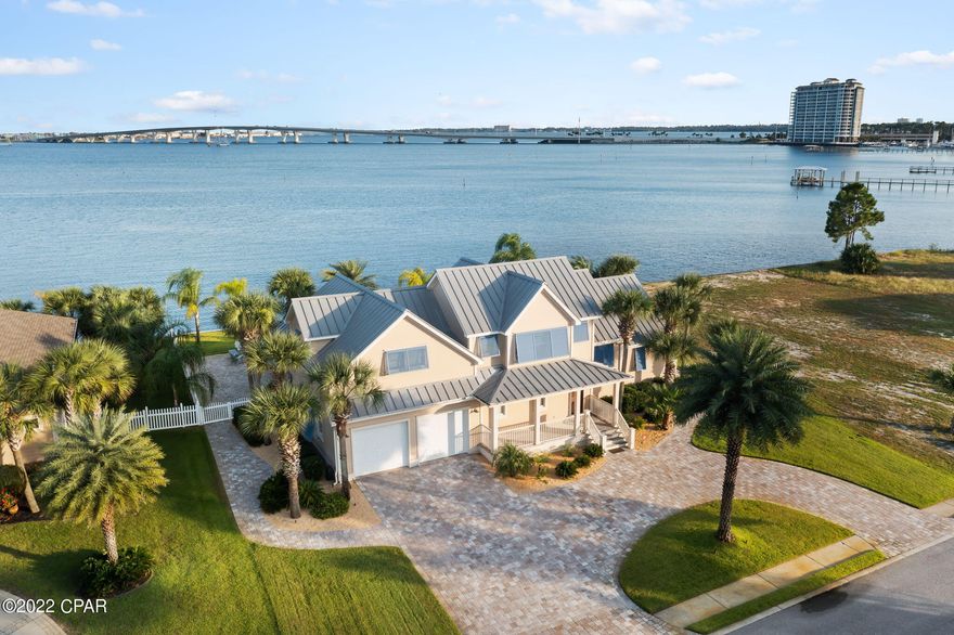 WOW!  Bay front home with so much to offer!  This four bedroom home custom built home is a show stopper and features so many upgrades.  Home also conveys a boat slip in the marina for a boat up to 40'.  The exterior of this home is a slice of paradise with a waterfront pool with sun deck, outdoor kitchen, fire pit, outdoor shower, and fish cleaning station.  The interior of the home is recently painted.  The kitchen is a chef's dream  with a Viking 6 burner stove, subzero refrigerator, silestone countertops, and double ovens.  Home also features Anderson windows and doors, Bose home theater surround sound, and so much more!  This home is located in Dolphin Bay- a gated waterfront community  with Tennis Courts and Marina.  This is a must see!!!!