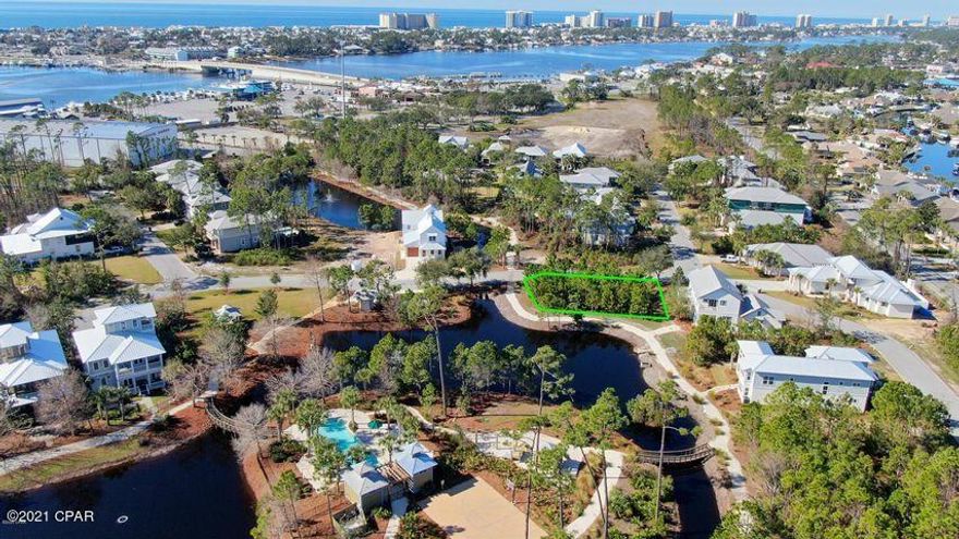 UNDER CONTRACT - CURRENTLY ACCEPTING BACK UP OFFERS.  Premier waterfront lot located in the beautiful first-class gated community of Martinique. Located at the east end of Grand Lagoon across from Capt. Anderson's Restaurant you will fall in love with the Old-Florida style architecture & lush landscaping. If you dream of building a custom home that takes full advantage of the waterfront view & location of this private home site, this one is for you. Residents enjoy endless amenities such as a community pool, basketball court, walking trails, & a community gazebo.  A series of walkways & nature paths link the amenities of this great community.  Within walking distance to award winning restaurants, marinas & fishing charters. Great schools, shopping, St. Andrews Park & the endless activity of Fl's sugar white beaches are just minutes away.