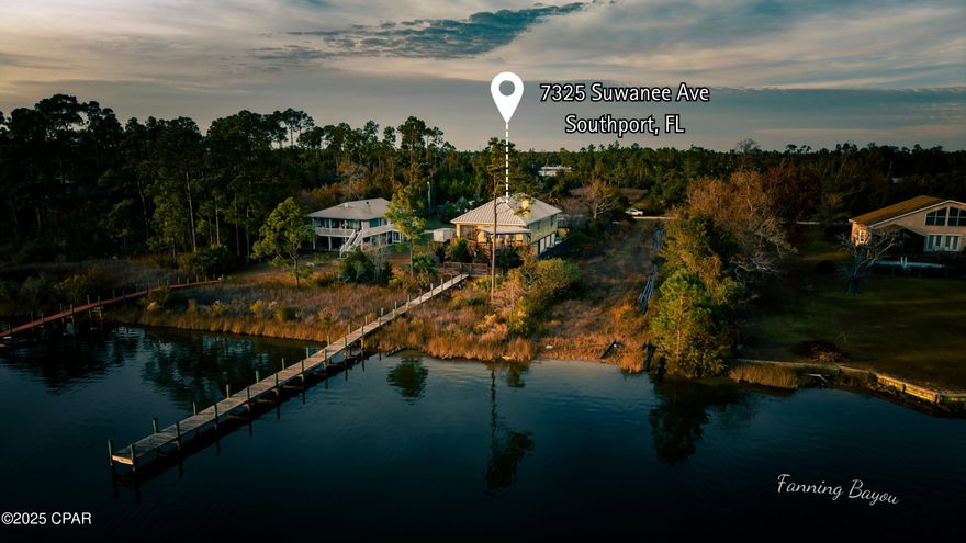 Custom-built in 2004 on 9′ pilings with 4′ of fill, this 2,172 sq ft, 3-bed, 2.5-bath home sits on the southeast corner of Fanning Oaks Peninsula with 50′ of frontage on Fanning Bayou/North Bay. Hardie board siding, 2020 metal roof, 2023 gutters, Rinnai tankless water heater, updated septic, and HVAC replaced in 2020. Open living with LVP flooring, built-ins, and bay views from every angle. Kitchen includes gas range, downdraft oven, double sinks, beverage fridge, under-counter fridge drawers, ice machine, pantry, and built-in hutch. Primary suite has dual baths, walk-ins, and office space. Extras include chair lift, dumbwaiter, screened porch, open deck, heated lap pool, and private dock with Gulf access. Lot is 0.47 acres, landscaped, fenced, and gated. Flood insurance approx. $990/yr. Assumable mortgage available.