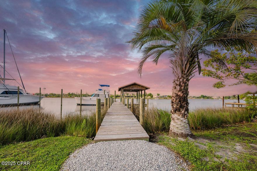 Welcome to 6905 Hugh Drive, where modern luxury meets coastal living! Completely remodeled from the studs up in 2023, this stunning 3-bedroom, 2-bathroom waterfront home sits on nearly 0.6 acres with 100 feet of deep, saltwater frontage on Callaway Bayou—your direct gateway to East Bay, Shell Island, and the Gulf beyond. Whether you're a boating enthusiast or simply seeking serenity by the water, this property delivers it all.

Step inside to a bright and open floorplan featuring soaring 15' vaulted ceilings and timeless luxury vinyl plank flooring throughout. The heart of the home is a custom chef's kitchen boasting stainless steel appliances, quartz countertops, an oversized center island, and white shaker cabinetry—all designed to impress. The kitchen flows seamlessly into an expansive living and dining area, making it the perfect space for entertaining.

No detail has been overlooked—this home offers brand-new everything, including HVAC, hot water heater, electrical wiring, sheetrock, a stunning metal copper roof, and so much more.

French doors off the living room lead to a large, covered back porch overlooking the bayou, ideal for outdoor gatherings and sunset views. The primary suite also features its own set of French doors opening to a private deck—perfect for enjoying your morning coffee while watching the sunrise over the water.

Boaters will love the brand-new dock with power (50 amp & 110 amp) and water, complete with a boat lift, and the added bonus of a nearby public boat ramp. The home also features a new privacy fence with a double gate and a gravel walkway offering additional parking with 11' clearance for your RV or boat.

This is more than a home—it's a lifestyle. Light, bright, and move-in ready, 6905 Hugh Drive offers peace, privacy, and endless waterfront adventures just minutes from town.

Schedule your private tour today and experience this bayou-front beauty for yourself!

Note: All measurements are approximate and details believe to be accurate. Buyers should verify if important