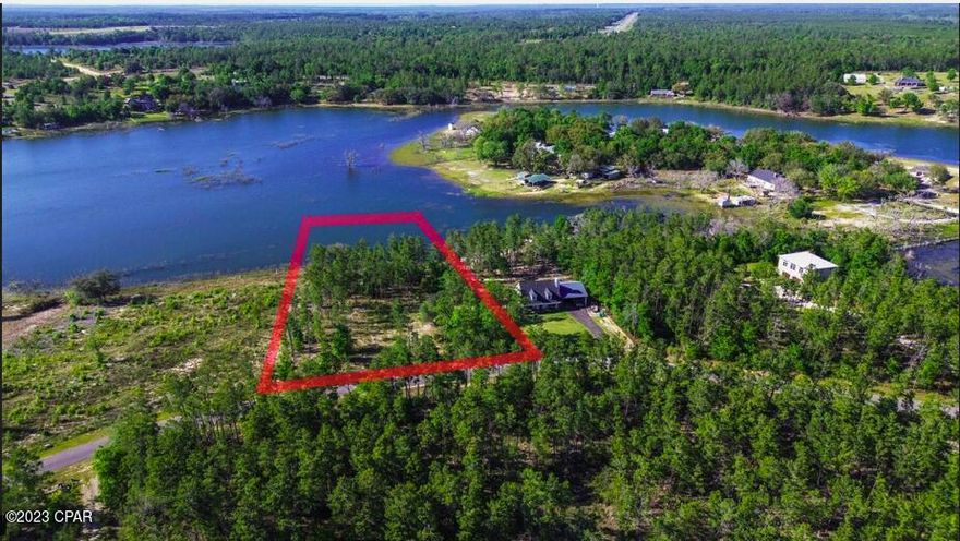 Looking for your own private slice of paradise? This 2-acre vacant lot on a lake is the perfect opportunity to create your dream home or cottage. Boasting 169 feet of lake frontage, you'll have stunning views of the water and plenty of space to enjoy all the activities that lakeside living has to offer. The property is just a short drive from Lynn Haven and Panama City. Located in a peaceful and serene setting, this property offers a rare opportunity to escape the hustle and bustle of city life and enjoy the tranquility of nature. Enjoy all kinds of water activities while taking in the scenic views. If you are looking to build a lakefront home, this is a must see! Pine Ridge Drive offers underground electric. A boundary and topographic survey from 2022 is included in the sale.