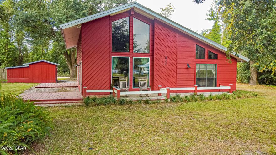 Come home to the country! This beautiful 2 bedroom, 2 bath cabin on over a third of an acre sits in a quiet neighborhood with mature trees and plenty of outdoor living space. Enjoy watching the wildlife of the nearby pond from your front porch or living room. The tongue and groove wood ceilings and beams & the brick floor-to-ceiling fireplace give this home a rustic touch, while the newly remodeled bathrooms with custom tiled walk-in showers, fresh paint & new light fixtures add a more modern flare. Floors are hardwood and tile throughout. Home also boasts custom made solid wood doors, a workshop with power, & a separate storage shed. The refrigerator,  hot water heater, some windows & doors all replaced in 2021. You must see this home to appreciate it!  All measurements are approximate.