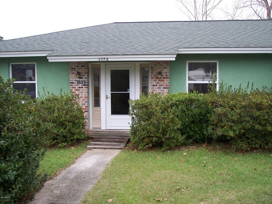 Flagpole out front of this stuccoed home on a nice street with a neighborhood feel! Features--an open living and dining area, Florida Room or den on back, new roof, new heating and cooling, and chain link fencing for pets in back yard. Beautiful camellia bushes, azaleas and other shrubs--and sprinkler system. A deep well is on property that can be used for the home or you can turn a valve and use community water (per owner). Inside the home, gas or electricity may be used for cooking. Home has been cleaned and left the terrazzo floors bare for your choice of tile, carpet, or wood flooring.